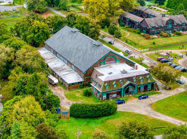 a massive 15,000-square-foot indoor riding arena, and grooms' quarters. Built during the height of the Gilded Age, this once-bustl