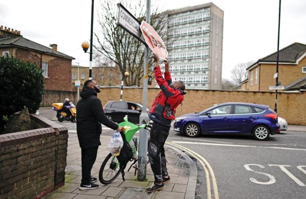 Witnesses said the men pulled the artwork down and quickly fled the area. 