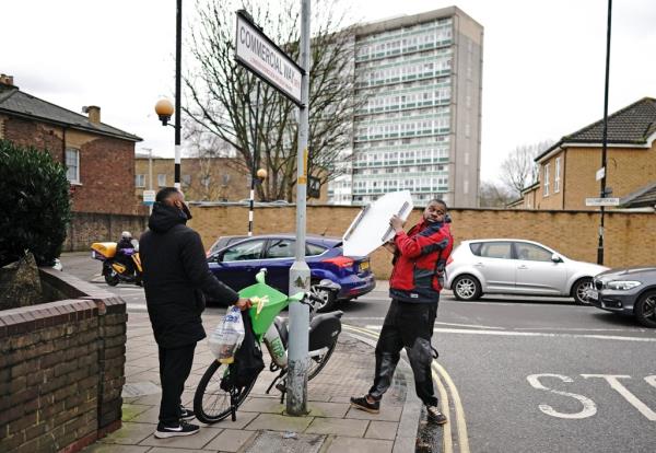 The men carrying Banksy's artwork