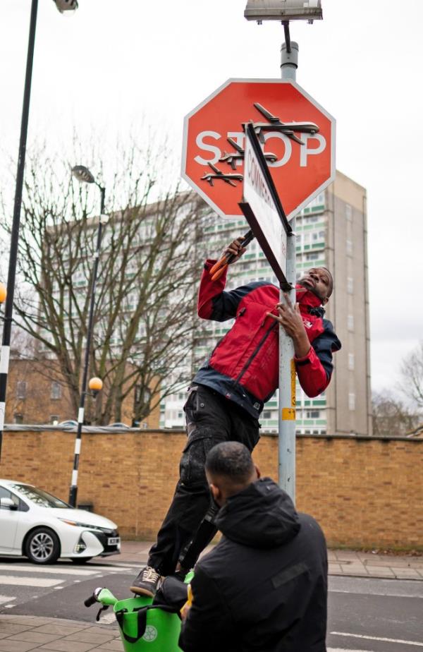 The man was pictured standing on top of a rented bike to bash the artwork down. 