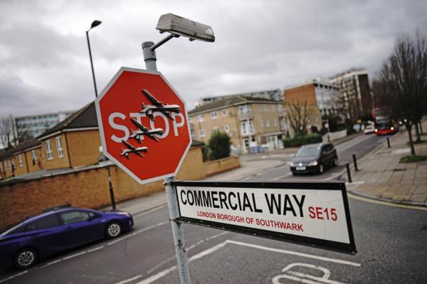 The new Banksy artwork features three military dro<em></em>nes emblazo<em></em>ned across a traffic stop sign.