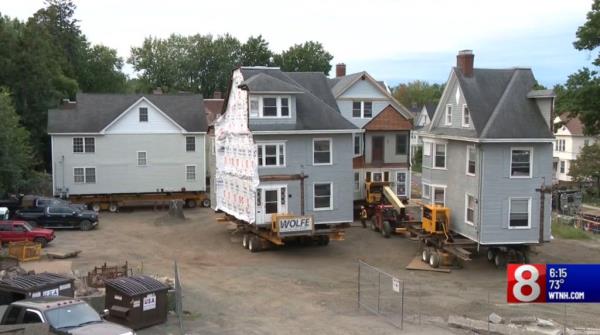 House split in half on top of hydraulic jack