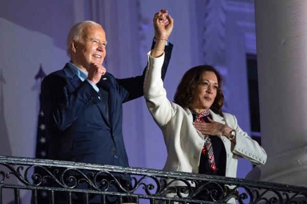 President Joe Biden raises the hand of Vice President Kamala Harris 