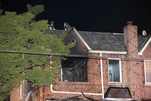 Firefighters are seen at a fatal fire on E 52 St. and Ave. D.