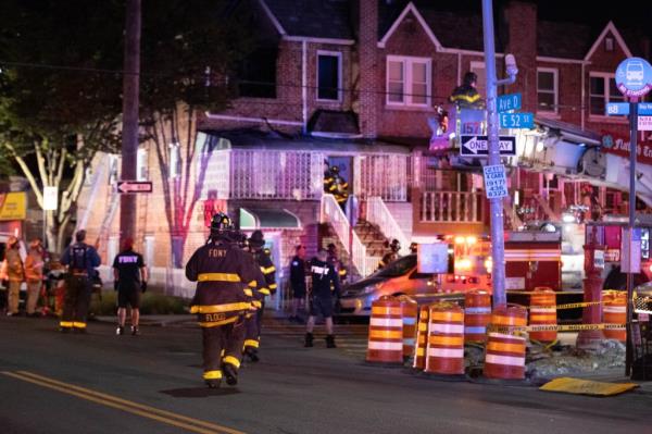 Firefighters are seen at a fatal fire on E 52 St. and Ave. D in Brooklyn.