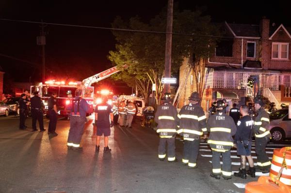 Firefighters are seen at a fatal fire on E 52 St. and Ave. D in Brooklyn.