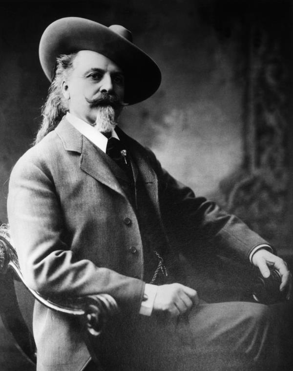 Studio portrait of American fro<em></em>ntiersman and entertainer William 'Buffalo Bill' Cody (1846 - 1917), wearing a three-piece suit, sitting in a chair. 