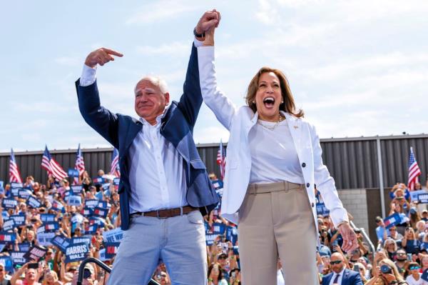 Democratic presidential nominee Vice President Kamala Harris is welcomed by running mate Democratic vice presidential nominee Minnesota Gov. Tim Walz.