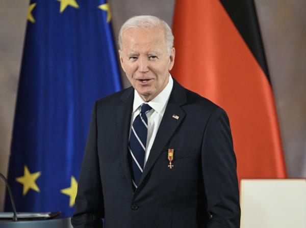 US President Joe Biden smiles after the German President awarded him with the Grand Cross special class of the Order of Merit.