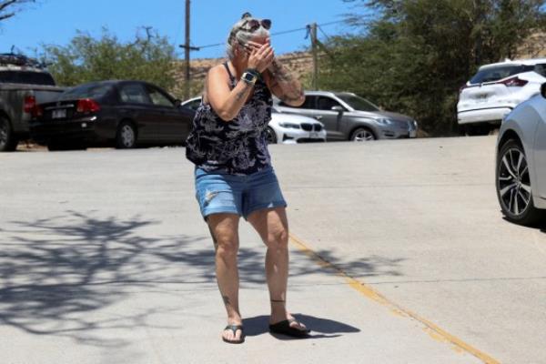 After hearing reports her home was destroyed along with her pets, Steff Baku-Kirkman reacts after wildfires driven by high winds were believed to have destroyed much of the historic town of Lahaina, in Kahului, Hawaii, U.S. August 9, 2023. REUTERS/Marco Garcia TPX IMAGES OF THE DAY