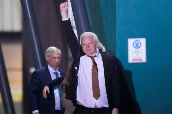 Assange waves after landing in Australia on June 26, 2024.