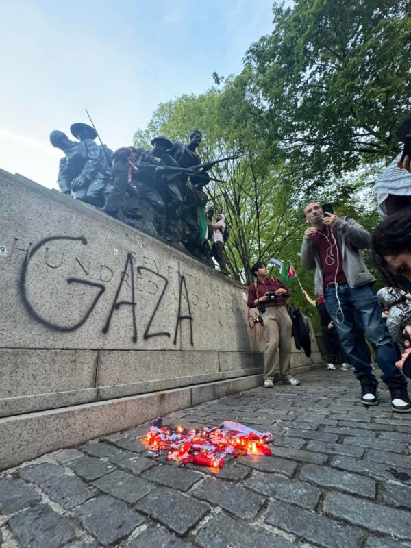 Several others were seen climbing on top of the infantrymen and waving Palestinian flags.