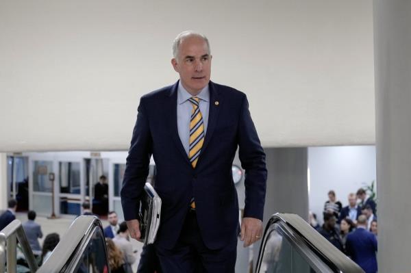 Sen. Bob Casey Jr., D-Pa., arrives at the Senate Subway on Capitol Hill Wednesday, March 20, 2024, in Washington. 