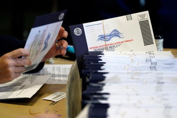 Chester County, Pa., election workers process mail-in and absentee ballots at West Chester University in West Chester, Pa., Nov. 4, 2020. 