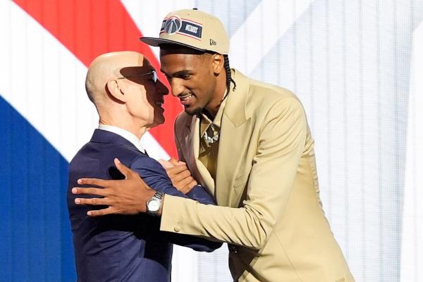 Alex Sarr, right, greets NBA commissio<em></em>ner Adam Silver after being selected as the second pick in the NBA draft.