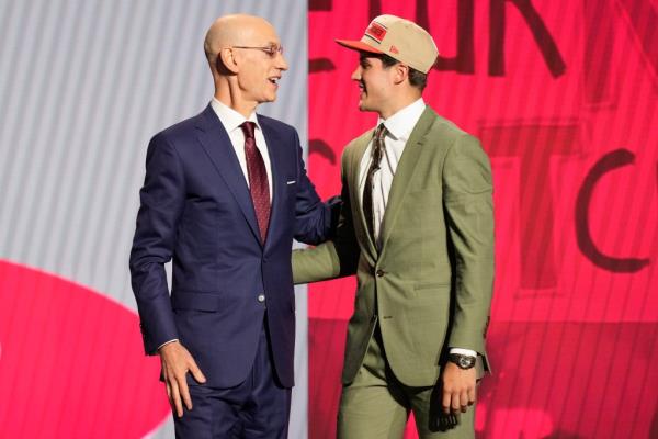 Reed Sheppard, right, greets NBA commissio<em></em>ner Adam Silver after being selected third overall by the Houston Rockets.