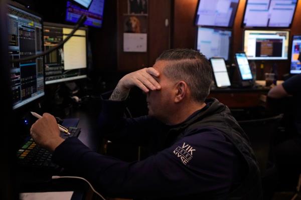 A trader on the floor of the New York Stock Exchange reacts to Friday's selloff.