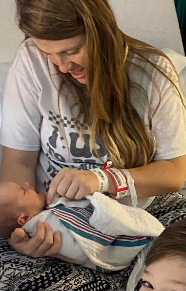 Cheyenne Ping holds her newborn daughter, Willow Jade Dellaquila, after her first bath in October 2023, in La Grange, Ky