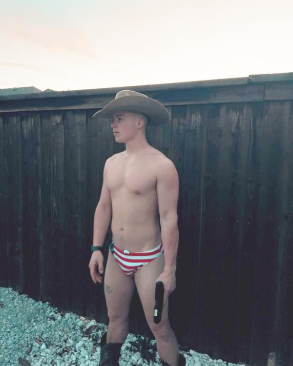 Michael Doherty in a cowboy hat and striped swimsuit celebrating 4th of July