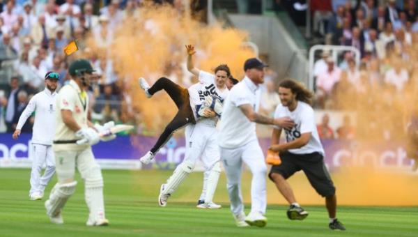 Mandatory Credit: Photo by Kieran McManus/Shutterstock (13984807ed) Just stop oil protestors run o<em></em>nto the field of play and throw orange powder before being stopped by England captain Ben Stokes and wicketkeeper Jo<em></em>nny Bairstow England v Australia, The Ashes, 2nd Test, Day One, LV=Insurance Men's Ashes Series, Cricket, Lords, London, UK - 28 Jun 2023