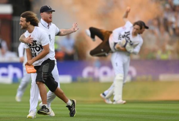 LONDON, ENGLAND - JUNE 28: Ben Stokes and Jo<em></em>nny Bairstow of England with 'Just Stop Oil' protestors during Day One of the LV=Insurance Ashes 2nd Test match between England and Australia at Lord's Cricket Ground on June 28, 2023 in London, England. (Photo by Philip Brown/Popperfoto/Popperfoto via Getty Images)