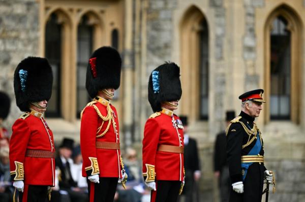 King Charles with Buckingham Palace guards. 