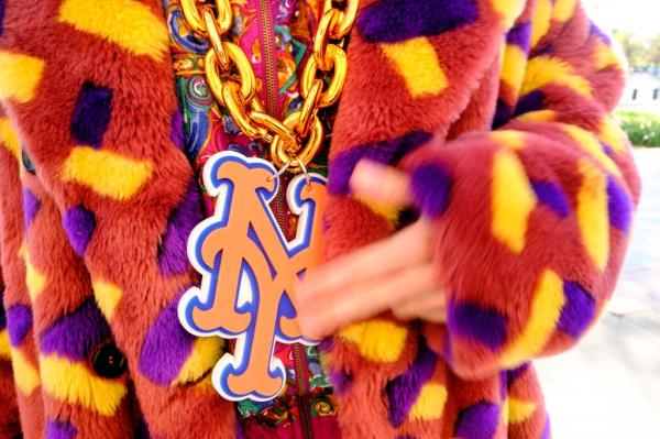 A photo of Wiener's funky attire, which includes an oversized chain with a Mets NY logo.