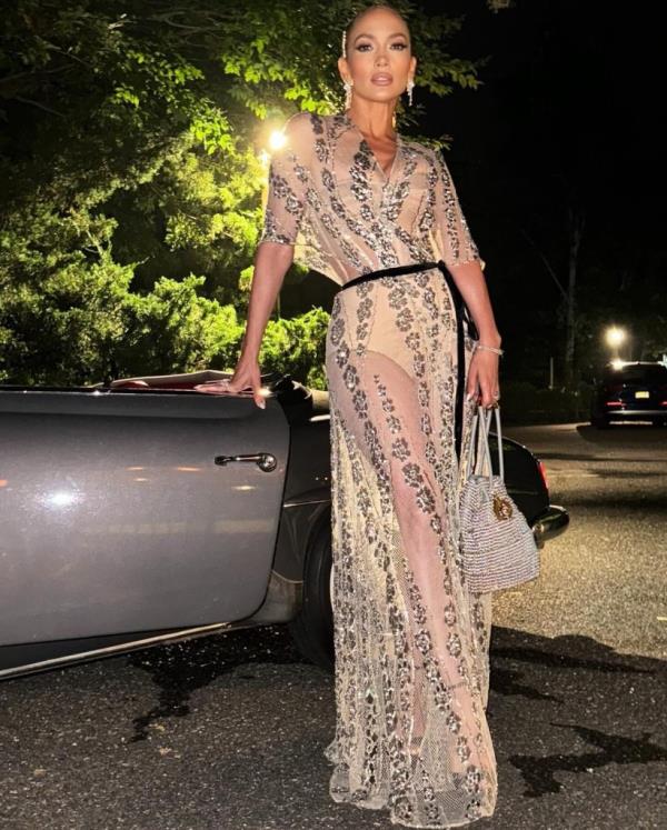 JLo poses by a car in a Dior gown on her birthday.