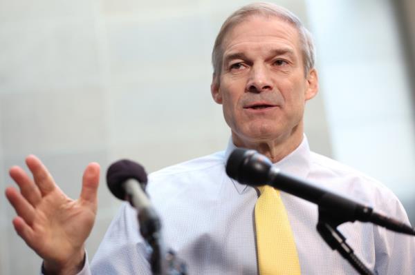 Chairman of House Judiciary Committee Jim Jordan speaks into micropho<em></em>nes at a press co<em></em>nference in front of reporters and cameras.