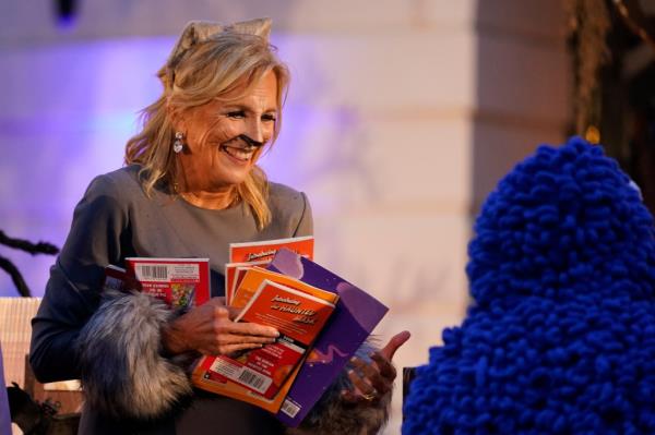 First lady Jill Biden gives treats to trick-or-treaters on the South Lawn of the White House