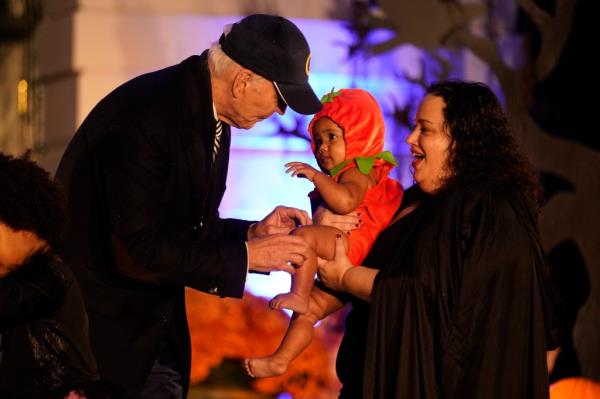 President Biden meets with a trick-or-treater at the White House. 