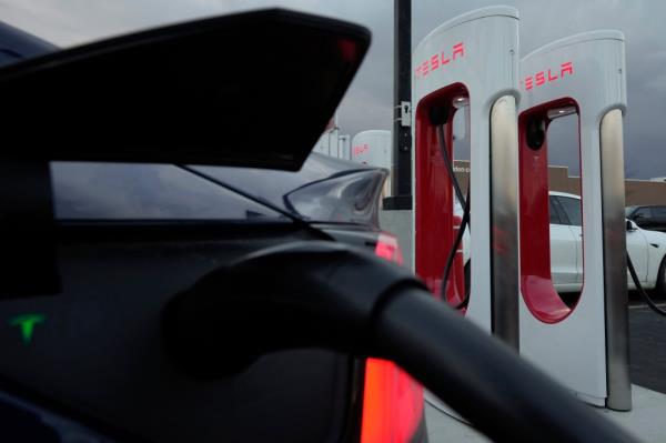 A vehicle charges at a Tesla Supercharger station.