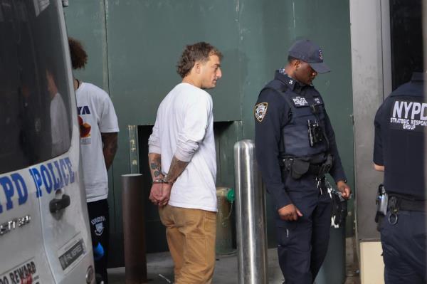 James Carlson cuffed walking from police car