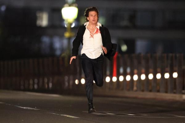 In photos obtained by The Post, Cruise, 61, can be seen sporting shaggy brunette hair and a white shirt drenched in fake blood and covered by a black coat as he sprints across Westminster Bridge as London's Big Ben and the Palace of Westminster provide a breathtaking backdrop. 