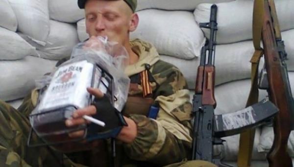 A Russian soldier seen drinking alcohol from a bottle 