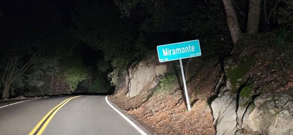 A sign for Miramonte, California on the side of a rural road.