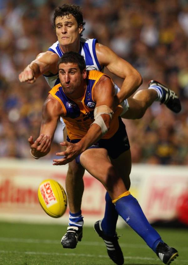 Scott Thompson of the Kangaroos spoils Dean Cox of the Eagles.