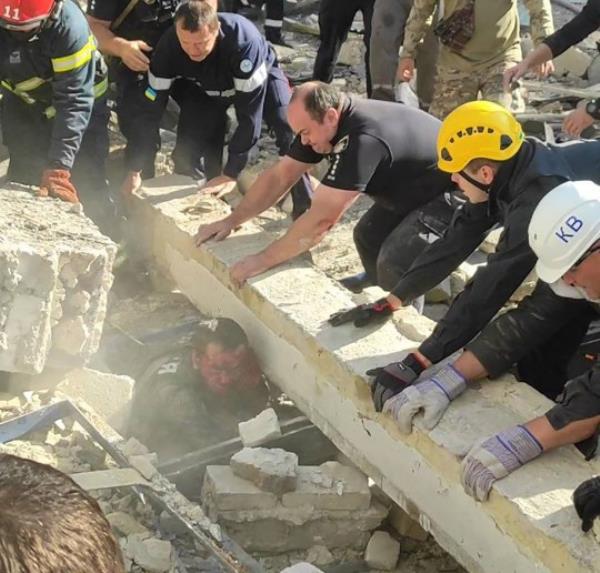 epa10848021 A handout photo made available by Ukraine's Minister of Internal Affairs, Ihor Klymenko, via telegram shows rescuers and police officers working to release a police officer from debris at a site of a missile strike in Kryvyi Rih, Dnipropetrovsk region, central Ukraine, 08 September 2023, amid the Russian invasion. A policeman was killed and 54 others, among them nine police officers, were injured as a result of a Russian missile strike targeting one of the police administration buildings in Kryvyi Rih on 08 September, Ukraine's Minister of Internal Affairs, Ihor Klymenko wrote on telegram. EPA/UKRAINE'S MINISTRY OF INTERNAL AFFAIRS HANDOUT -- BEST QUALITY AVAILABLE -- MANDATORY CREDIT: IHOR KLYMENKO, UKRAINE'S MINISTER OF INTERNAL AFFAIRS -- HANDOUT EDITORIAL USE ONLY/NO SALES