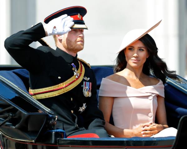 Prince Harry, Duke of Sussex and Meghan, Duchess of Sussex travel in a horse drawn carriage during Trooping The Colour 2018 on June 9, 2018 in London, England. 