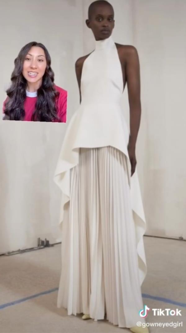 Bingham on TikTok looking at unco<em></em>nventional dresses, the one shown in the screenshot is a floor length white gown with a ruffled underskirt