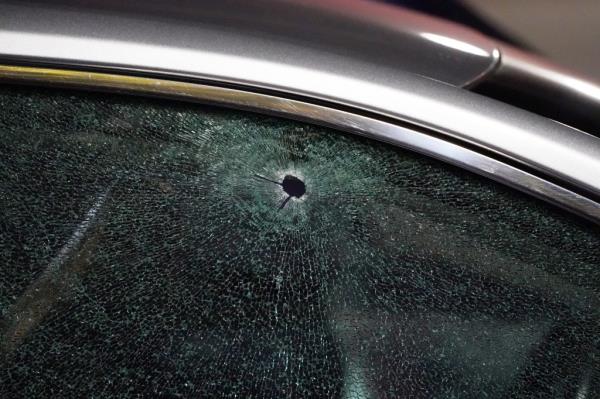 A Lyft driver narrowly avoided being shot when a stray bullet pierced his passenger side window.