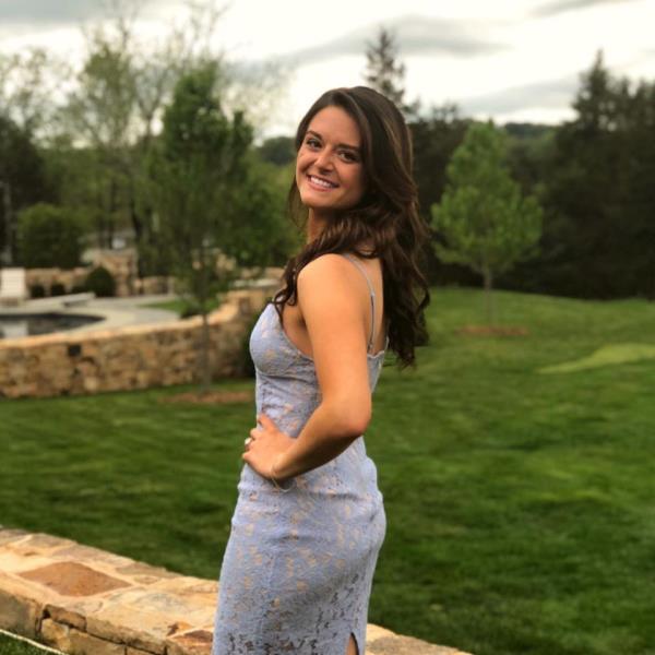 Morgan Bettinger is pictured standing in a blue dress.