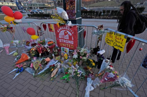 A person views a memorial dedicated to the victims of last week's mass shooting in front of Unio<em></em>n Station, Sunday, Feb. 18, 2024, in Kansas City, Mo.