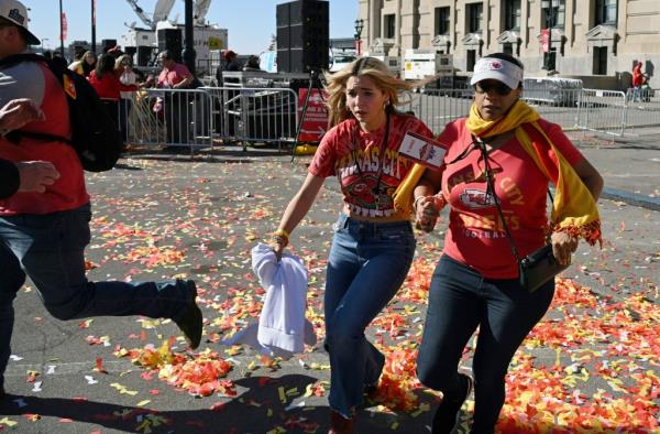 People flee after shots were fired near the Kansas City Chiefs' Super Bowl LVIII victory parade on February 14, 2024, in Kansas City, Missouri.