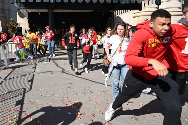 People running in a crowd after shots were fired during Kansas City Chiefs' Super Bowl LVIII victory parade in Kansas City, Missouri.