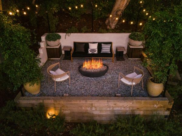 At night, a fire pit glows.