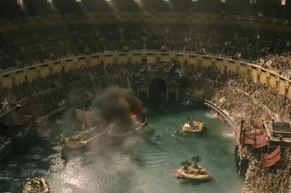 A large arena with crowd watching a boat in water, scene from Gladiator II trailer featuring Paul Mescal, Pedro Pascal, Denzel Washington