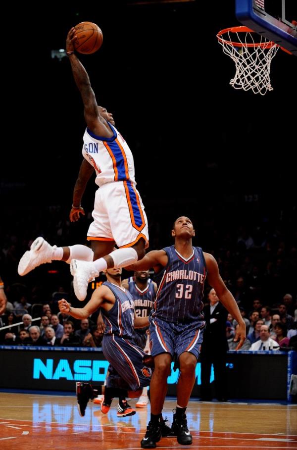 Nate Robinson of the New York Knicks dunks in front of Boris Diaw of the Charlotte Bobcats in the second half at Madison Square Garden in New York,  January 7, 2010.  