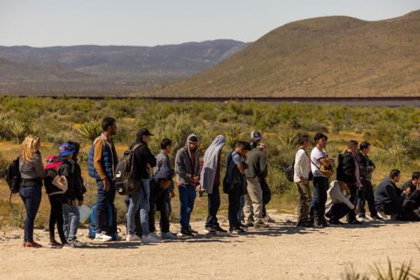 Migrants walk around the border fence and into the United States in Jacumba Hot Springs, wher<em></em>e they are detained by Border Patrol and prepared for processed for immigration intake.