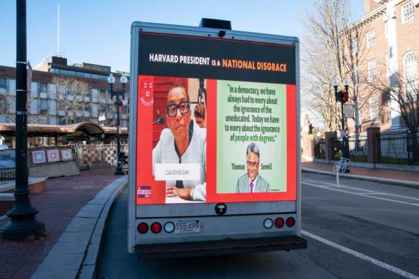 A billboard in Harvard Square displays.a photo of Claudine Gay and calls her a 